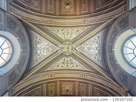A stunning view of an ornately decorated ceiling, featuring a grand, symmetrical design. Intricate carvings, gold accents, and detailed reliefs inside Pio-Clementino Museum 130107102