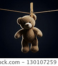 A fluffy brown teddy bear with a light snout and ears hangs from a wooden clothespin on a thin rope against a dark background. Generative AI. 130107259