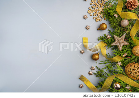 Golden Christmas Decorations with Greenery on Light Background Golden Christmas Decorations with Greenery on Light Background 130107422