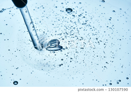 A drop of cosmetic product with abundant bubbles in blue tones. 130107590