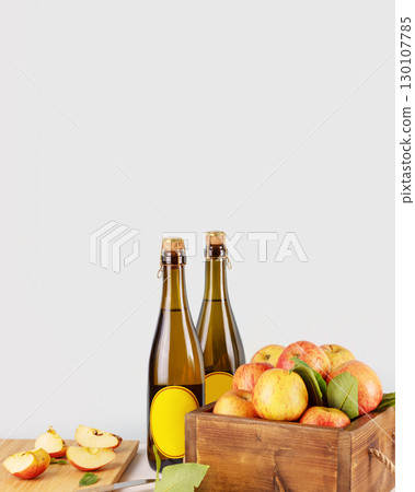 Apple cider drink or fermented fruit drink. Bottles with cider and red organic apples in a wooden box on blue background with copy space. Healthy eating, eco friendly product. Apple, low alcohol drink Apple cider drink or fermented fruit drink. Bottles with cider and red organic apples in a wooden box on blue background with copy space. Healthy eating, eco friendly product. Apple, low alcohol drink 130107785