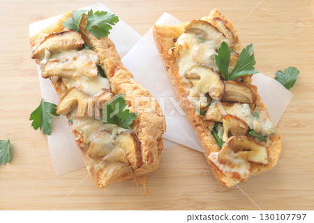 Bruschetta with porcini mushrooms and cheese. Food and quality products cooked in aero fryer. Traditional cuisine of Italy. Bruschetta with porcini mushrooms and cheese. Food and quality products cooked in aero fryer. Traditional cuisine of Italy. 130107797