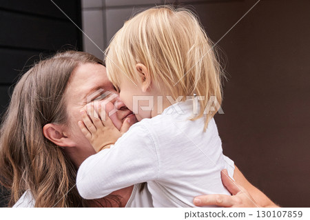 Caucasian female child embracing adult woman with tenderness and joyful Caucasian female child embracing adult woman with tenderness and joyful 130107859