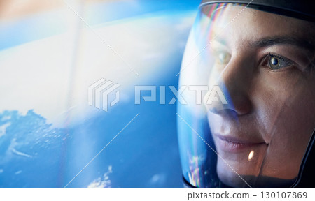 Close up view of woman in glassed space helmet against blue background Close up view of woman in glassed space helmet against blue background 130107869