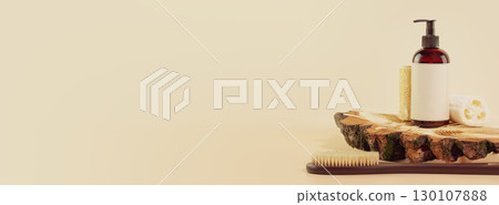 Eco friendly spa relax banner with mockup of bath beauty product, loofahs and washing brush on wooden podium with rye and wheat ears. Wellness and skin care treatment. Concept of me time and self care Eco friendly spa relax banner with mockup of bath beauty product, loofahs and washing brush on wooden podium with rye and wheat ears. Wellness and skin care treatment. Concept of me time and self care 130107888