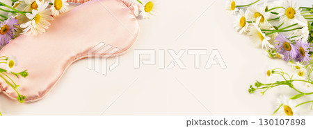 Concept of Good sleep, no depression, me time and self-care. Banner with pink sleeping mask with wild flowers on a white background with copy space. Soft focus style, banner size Concept of Good sleep, no depression, me time and self-care. Banner with pink sleeping mask with wild flowers on a white background with copy space. Soft focus style, banner size 130107898