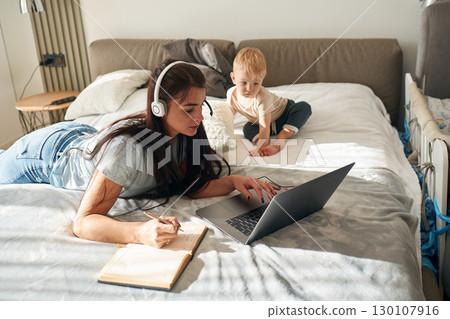 Mother with her little son is at home in domestic room 130107916