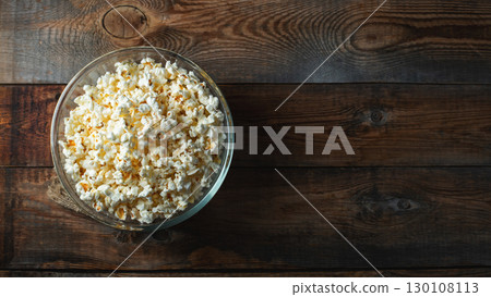 Popcorn on wood color background.Food and snack concepts ideas.Minimal style top view mockup Popcorn on wood color background.Food and snack concepts ideas.Minimal style top view mockup 130108113