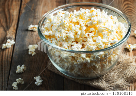 Popcorn on wood color background.Food and snack concepts ideas.Minimal style top view mockup Popcorn on wood color background.Food and snack concepts ideas.Minimal style top view mockup 130108115