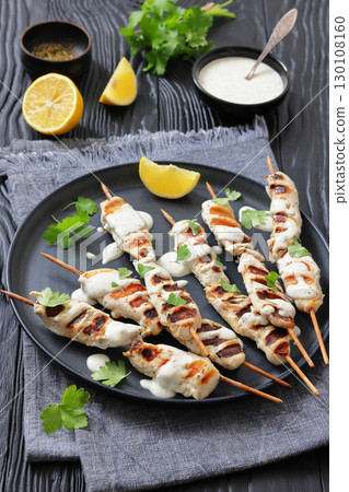 Greek style grilled chicken souvlaki on a plate Greek style grilled chicken souvlaki on a plate 130108160