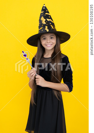 Teen girl in witch costume hold magic wand. Happy Halloween. Girl witch in Halloween costume isolated on yellow. Trick or treat. All Hallows party. All Hallows witch. October 31. Witches and wizards Teen girl in witch costume hold magic wand. Happy Halloween. Girl witch in Halloween costume isolated on yellow. Trick or treat. All Hallows party. All Hallows witch. October 31. Witches and wizards 130108195