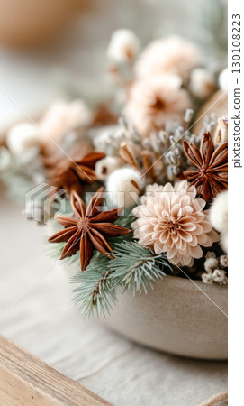 Beautiful floral arrangement featuring soft pastel flowers and aromatic spices in a rustic bowl, creating a warm and inviting atmosphere for decor 130108223