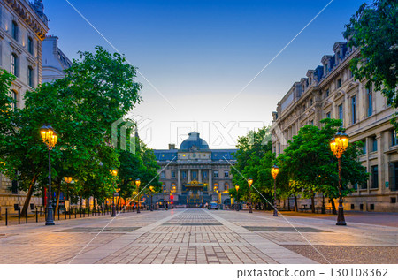 Paris street with lamp lights on sunset twilight in historic city center, Paris cityscape evening view, Place Louis-Lepine square, Palais de Justice palace building on de la Cite island, France Paris street with lamp lights on sunset twilight in historic city center, Paris cityscape evening view, Place Louis-Lepine square, Palais de Justice palace building on de la Cite island, France 130108362