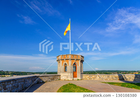 Small tower with Walloon flag on Citadel of Namur Citadelle de Namur stone fortress on hill in historical city centre, skyline horizon background, Wallonia, Walloon Region, Belgium 130108380