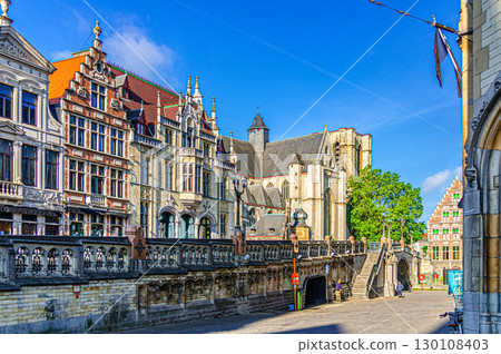 Old traditional houses buildings and Saint Michael's Roman Catholic Church Sint-Michielskerk near Saint Michael's Bridge Sint-Michielsbrug in Ghent city historical center, Flemish Region, Belgium Old traditional houses buildings and Saint Michael's Roman Catholic Church Sint-Michielskerk near Saint Michael's Bridge Sint-Michielsbrug in Ghent city historical center, Flemish Region, Belgium 130108403