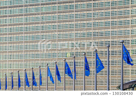 Berlaymont building wall and European Union EU flags, modernism architecture style, modern high-rise office building, abstract details of facade wall, patterned cells, Brussels city, Belgium Berlaymont building wall and European Union EU flags, modernism architecture style, modern high-rise office building, abstract details of facade wall, patterned cells, Brussels city, Belgium 130108430