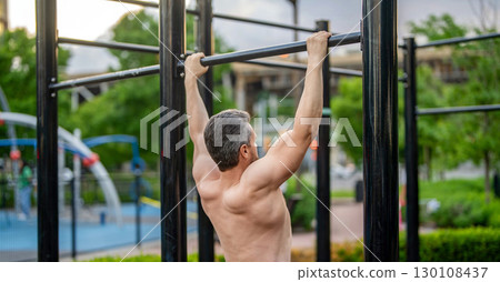 Strong athlete. Man pullup. Muscular man sportsman with strong back muscle. Sport pullup workout. Sport training. Man sportsman do pulling exercise. Pull up exercise 130108437