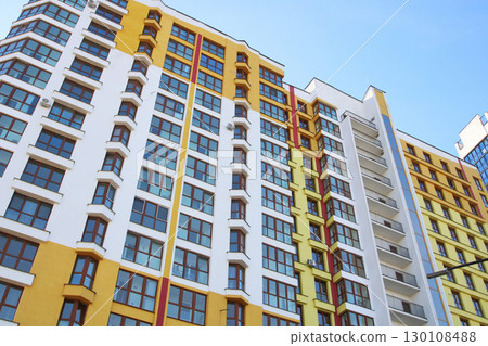 A tall and impressive building featuring numerous windows and balconies A tall and impressive building featuring numerous windows and balconies 130108488
