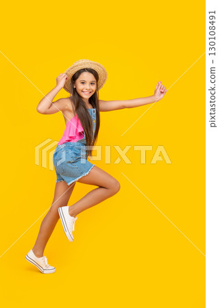 cheerful teen girl in straw hat running on yellow background cheerful teen girl in straw hat running on yellow background 130108491