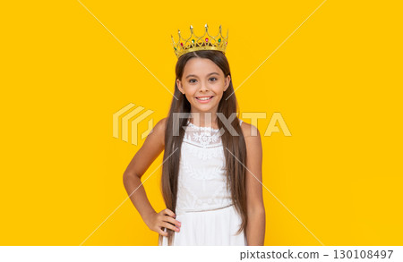 smiling teen girl in crown on yellow background smiling teen girl in crown on yellow background 130108497