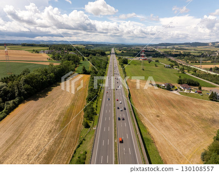 Aerial view of cars driving on highway crossing the Austrian countryside near Neumarkt an der Ybbs in lower Austria, with fields and forests 130108557