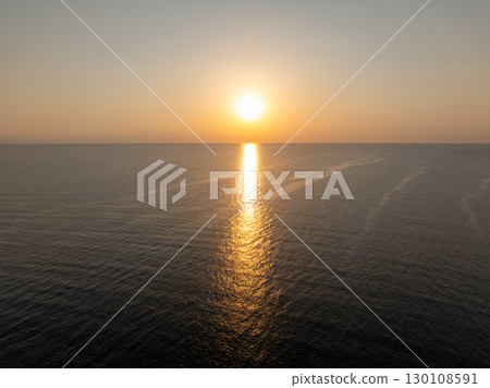 Golden sunset creating a path of light on the calm Aegean sea, offering a breathtaking view of nature's beauty in Kassandra, Greece Golden sunset creating a path of light on the calm Aegean sea, offering a breathtaking view of nature's beauty in Kassandra, Greece 130108591