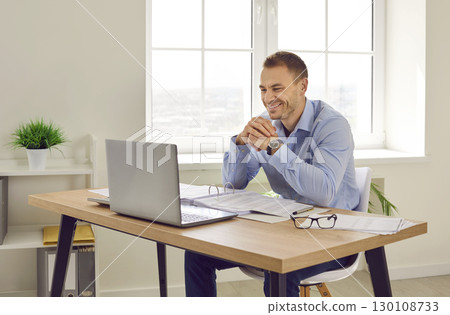 Business man working and chatting online or having video conference call on laptop. Business man working and chatting online or having video conference call on laptop. 130108733