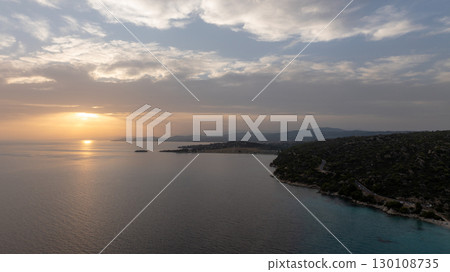 Golden sunset reflecting on the Aegean sea along the Sithonia coastline in СHalkidiki, Greece, creating a tranquil scene at dusk Golden sunset reflecting on the Aegean sea along the Sithonia coastline in СHalkidiki, Greece, creating a tranquil scene at dusk 130108735