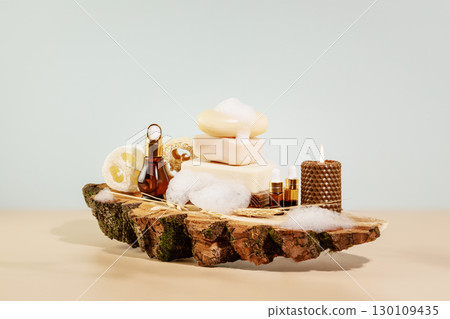 Eco friendly spa relax composition with bars of soap, loofahs, natural oils for skin care, candles and soap foam on wooden podium. Wellness and skin care treatment. Concept of me time and self care Eco friendly spa relax composition with bars of soap, loofahs, natural oils for skin care, candles and soap foam on wooden podium. Wellness and skin care treatment. Concept of me time and self care 130109435