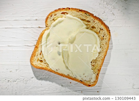 slice of toast with cream cheese 130109443
