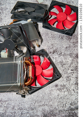 From above of vintage red CPU cooler also called PC cooling fan placed on surface From above of vintage red CPU cooler also called PC cooling fan placed on surface 130109810