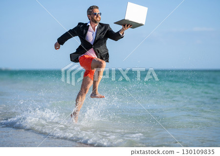 manager businessman at beach. retreat for the busy businessman. summer vacation of manager business man. Businessman manager enjoying a beach break. Elevating your business to new heights 130109835