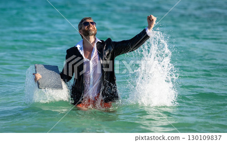 Business man manager on summer trip. Summer business. manager business man on summer vacation. Summer weekend and remote freelance work. business man with laptop Business man manager on summer trip. Summer business. manager business man on summer vacation. Summer weekend and remote freelance work. business man with laptop 130109837