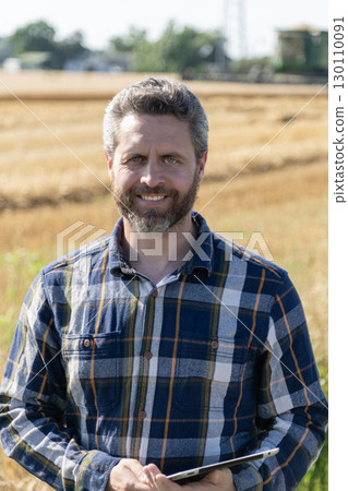 Crop harvest. Farmer agronomist man with tablet in field. Technology of modern agriculture. Farmer man working on field with tablet. Hispanic farmer with tablet check harvest. Agricultural business 130110091