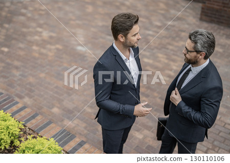 Business partner outdoor. Two businessmen in suit. Business conversation. Project partner talking. Successful businessmen. Copy space. Successful partnership communication. Business success 130110106