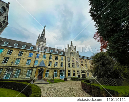 Linear facade of modern buildings in Leuven with tower and green surroundings 130110131