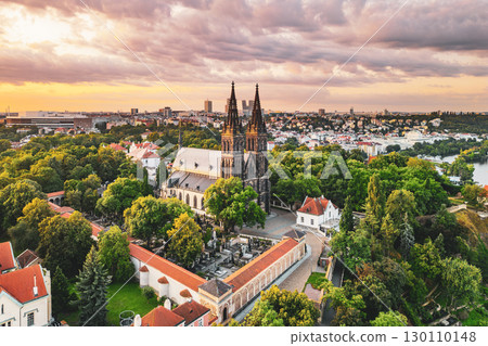 Sunrise illuminates the stunning Vysehrad Basilica of St. Peter and St. Paul, surrounded by lush greenery and the picturesque skyline of Prague. The serene atmosphere invites peaceful reflection. Sunrise illuminates the stunning Vysehrad Basilica of St. Peter and St. Paul, surrounded by lush greenery and the picturesque skyline of Prague. The serene atmosphere invites peaceful reflection. 130110148