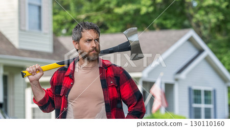 Lumberjack at his house with ax. Lumberjack sweating hold heavy axe. Strong man work in neighborhood. Lumberjack men with axe. Lumberjack carries axe. Handsome man with axe, copy space 130110160
