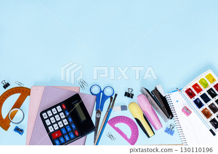 top view of school subjects on a blue background with space for text 130110196