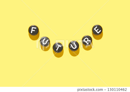 Creative arrangement of alphabet beads spelling future on vibrant yellow 130110462