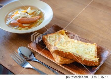 Breakfast with French toast and vegetable soup with sausage Breakfast with French toast and vegetable soup with sausage 130110755