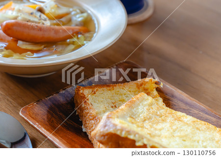 Breakfast with French toast and vegetable soup with sausage 130110756