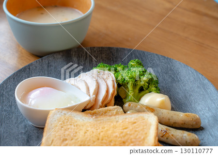 Breakfast of toast, chicken ham, sausage, soft-boiled egg, and soup Breakfast of toast, chicken ham, sausage, soft-boiled egg, and soup 130110777