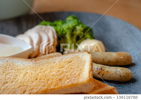 Breakfast of toast, chicken ham, sausage, soft-boiled egg, and soup 130110780