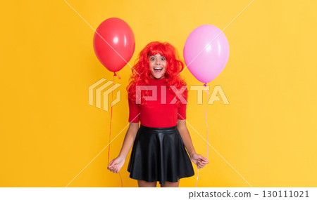 amazed teen child with party balloon on yellow background amazed teen child with party balloon on yellow background 130111021