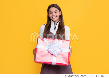 glad kid with present box on yellow background glad kid with present box on yellow background 130111028