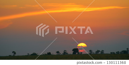 Solar disk and beautiful red sunset over the earth's surface. 130111368