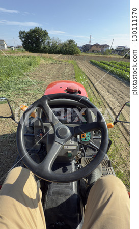 Shooting from the driver's seat of a tractor, plowing a field of grass Shooting from the driver's seat of a tractor, plowing a field of grass 130111570