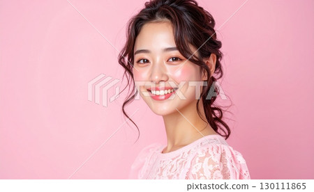 Woman in pastel pink blouse with lace, magazine-style shot from above the shoulders 130111865