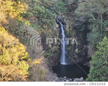 Waterfall surrounded by autumn leaves 130112318